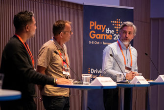 Men speaking on a stage