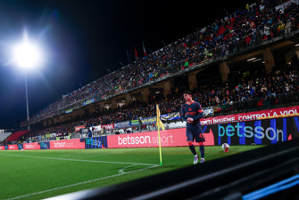 Football player in front of banner adverts