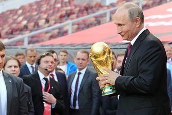 Putin holding the 2018 world cup trophy
