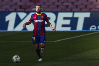 Football player in front of sign for 1XBet